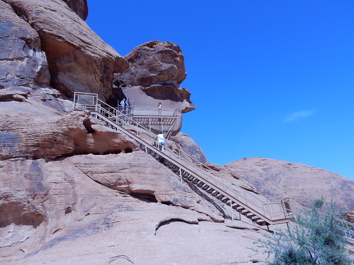 climbing steps to see petroglyphs (writings in the desert)